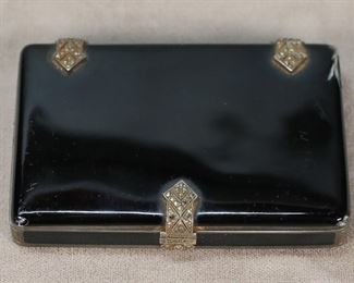 371	George Stockwell Sterling & Enamel Snuff Box	Hallmarked English import sterling silver, enamel & marcasite snuff / tobacco box. Sterling box with enamel lid and sides, marcasite decorated hinges and clasp. Interior and interior of lid stamped 925 with George Stockwell, London circa 1929 maker's mark and import mark. 3"L x 2"W x 1/2"H. 98 grams total. Tarnishing to interior, chip and crack to enamel on top corner.
