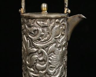 375	Russian 84 Silver Demitasse Pot	Russian 84 (.875) silver demitasse or teapot. Repousse decoration of birds with fruit and flowers. Russian 84 silver hallmark and IIA on the underside. 8 1/4"H including handle. 428 grams total. Tarnished, with some pitting.
