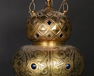 395	Victorian Moorish Style Hanging Lamp	"Victorian Moorish style hanging lamp. Three chains supporting brass lamp set with colored glass faux gemstones and topped with moon and star finial. Scuffs and wear to brass throughout lamp. Light marks and spots to surface of brass. Lighting has not been tested.

12 1/2"" W x 18 1/2"" H. 8 lbs."
