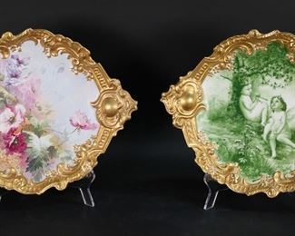 402	2 Limoges Porcelain Plates	2 Limoges porcelain plates. Hand painted with floral decoration, signed illegibly; scene with cherubs, signed E. Lajouanie. Both with gilt decorated rims. Both marked L.S. & S. Limoges France, with additional green marks. Each 15"W at handles. Losses to gilt painting on both, chip to handle of floral plate.
