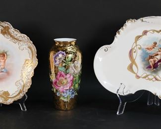 405	3 Pieces Limoges Porcelain	3 pieces Limoges French porcelain. Gilt porcelain Fontanille and Marraud vase with hand painted floral decoration, 7 7/8"H; VF Limoges plate with Cupids and gilt foliate rim, 9 1/2"-diameter; platter with Cupid and Aglaia, 12 5/8"L. VF Limoges plate losses to gilt decoration around rim, lines to the underside; losses to decoration on rim of Aglaia platter, scratches to center image.
