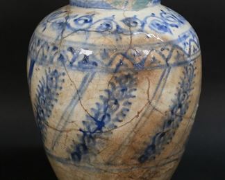 408	Persian Blue & White Pottery Vase	Blue and white Persian pottery vase. 9 3/4"H. Lines and repairs throughout, chips to rim.
