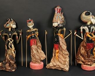 419	4 Indonesian Puppets	4 Indonesian puppets. Carved and painted wood. 2 with wooden stands. Largest 25"L. One hand repaired and chipped, one hand chipped.
