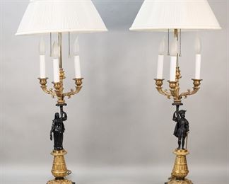 420	Pair of Empire Style Figural Candelabra Lamps	Pair of empire style figural lamps. Patinated and gilt metal, with figures male and female figures. 3 light candelabra and two additional lights above. Each 33 1/4"H. Losses and scratches to patina on both figures, tears to shades.
