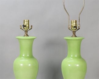 422	Pair of Green Glazed Porcelain Vase Form Lamps	"Pair of green glazed porcelain vase form lamps. 20th century. Each on fitted lacquered bases. Both lamps have been tested and work. Staining and wear to surface of lamps. Chips and losses throughout lacquer on bases, split to one. Harp present on only one lamp. 

19 1/8"" H (without harp). 29"" H with harp."
