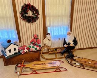 folk art house and antique sleds