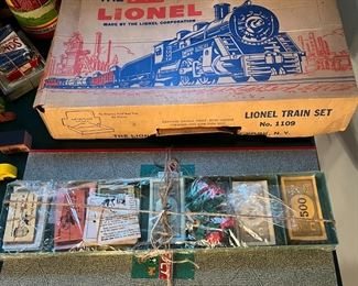 Lionel train set and Monopoly gameboard/pieces