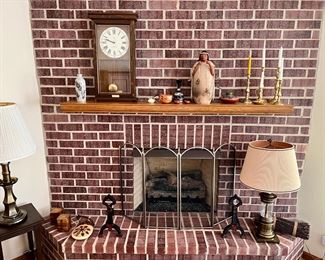 Stiffel lamps, mantle clock, Tammy Tarbell clay woman sculpture, brass candlesticks and antique andirons