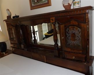 Ornate wooden headboard with storage