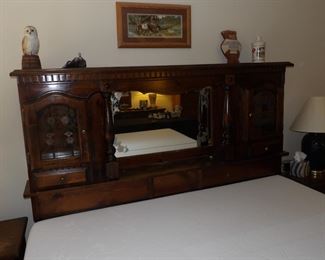 Ornate wooden headboard with storage