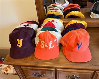 A bunch of vintage community softball team hats