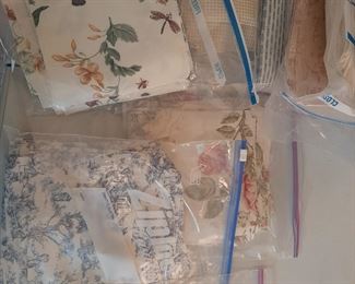 Several packages of already cut squares for quilting