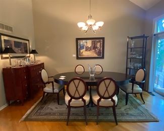 Barbara Barry for Baker Furniture Dining Table with X-Back Dining Chairs 

Oval Dining Table 
108” Width
48” Depth
29 3/4” Height 

Including Two 20" leaves and Protective Padding

The dimensions for the oval X-back dining Captain Chairs with Arms are…
27" Width
19 1/2" Depth
18” Seat Height 
38 1/2" Back Height

The oval X-back side chair dimensions are…
23" Wide
24" Depth
18” Seat Height 
38 1/2" Back Height

Magnificent signature design by Barbara Barry. Barbara Barry intends for her furniture designs to connect people to the splendor of the natural world around them. Barry’s admiration for organic materials and the subdued color palettes make her furniture designs timeless! Simple and calming, her furniture is quietly elegant and has garnered Barry renown worldwide as a leader in interior design. Barry has created exclusive furniture collections and home decor for other legendary brands as well…

In the style of modern 
Mahogany color