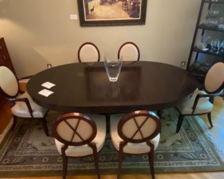 Barbara Barry for Baker Furniture Dining Table with X-Back Dining Chairs 

Oval Dining Table 
108” Width
48” Depth
29 3/4” Height 

Including Two 20" leaves and Protective Padding

The dimensions for the oval X-back dining Captain Chairs with Arms are…
27" Width
19 1/2" Depth
18” Seat Height 
38 1/2" Back Height

The oval X-back side chair dimensions are…
23" Wide
24" Depth
18” Seat Height 
38 1/2" Back Height

Magnificent signature design by Barbara Barry. Barbara Barry intends for her furniture designs to connect people to the splendor of the natural world around them. Barry’s admiration for organic materials and the subdued color palettes make her furniture designs timeless! Simple and calming, her furniture is quietly elegant and has garnered Barry renown worldwide as a leader in interior design. Barry has created exclusive furniture collections and home decor for other legendary brands as well…

In the style of modern 
Mahogany color