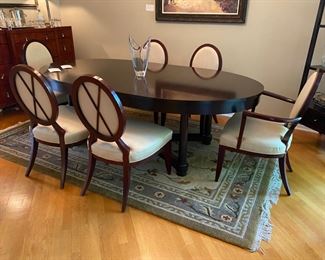 Barbara Barry for Baker Furniture Dining Table with X-Back Dining Chairs 

Oval Dining Table 
108” Width
48” Depth
29 3/4” Height 

Including Two 20" leaves and Protective Padding

The dimensions for the oval X-back dining Captain Chairs with Arms are…
27" Width
19 1/2" Depth
18” Seat Height 
38 1/2" Back Height

The oval X-back side chair dimensions are…
23" Wide
24" Depth
18” Seat Height 
38 1/2" Back Height

Magnificent signature design by Barbara Barry. Barbara Barry intends for her furniture designs to connect people to the splendor of the natural world around them. Barry’s admiration for organic materials and the subdued color palettes make her furniture designs timeless! Simple and calming, her furniture is quietly elegant and has garnered Barry renown worldwide as a leader in interior design. Barry has created exclusive furniture collections and home decor for other legendary brands as well…

In the style of modern 
Mahogany color