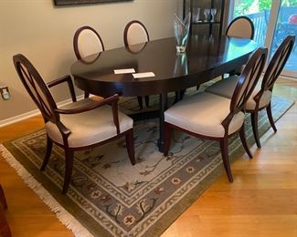 Barbara Barry for Baker Furniture Dining Table with X-Back Dining Chairs 

Oval Dining Table 
108” Width
48” Depth
29 3/4” Height 

Including Two 20" leaves and Protective Padding

The dimensions for the oval X-back dining Captain Chairs with Arms are…
27" Width
19 1/2" Depth
18” Seat Height 
38 1/2" Back Height

The oval X-back side chair dimensions are…
23" Wide
24" Depth
18” Seat Height 
38 1/2" Back Height

Magnificent signature design by Barbara Barry. Barbara Barry intends for her furniture designs to connect people to the splendor of the natural world around them. Barry’s admiration for organic materials and the subdued color palettes make her furniture designs timeless! Simple and calming, her furniture is quietly elegant and has garnered Barry renown worldwide as a leader in interior design. Barry has created exclusive furniture collections and home decor for other legendary brands as well…

In the style of modern 
Mahogany color