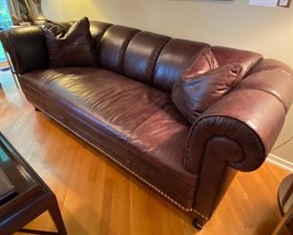 Chesterfield Style Barbara Barry For Baker Paris Sofa 
84” Width
34” Depth
30” Back Height
Barbara Barry Paris Sofa 822-84 in L1222 Leather -  No. 822-84 PARIS SOFA Contemporized Chesterfield with a pulled channel and a bench seat rather than tufting. 
Welt trim , oversized nickel nailhead trim. Square tapered legs. Nickel cap and caster. Inspired by a mid-century example. 
This sofa takes the Chesterfield to an entirely different place. The low, but long, proportions are important for downtown living - full-sized but not excessively so… Designed to be Art Deco, but a change of fabric and trim allow a fresh traditional look. The low back allows it to float easily or anchor a setting under a picture window. One of Baker's most published designs!!!
PARIS SOFA 822-84 THE BARBARA BARRY COLLECTION FINISH JAVA