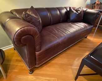 Chesterfield Style Barbara Barry For Baker Paris Sofa 

84” Width
34” Depth
30” Back Height

Barbara Barry Paris Sofa 822-84 in L1222 Leather -  No. 822-84 PARIS SOFA Contemporized Chesterfield with a pulled channel and a bench seat rather than tufting. 

Welt trim , oversized nickel nailhead trim. Square tapered legs. Nickel cap and caster. Inspired by a mid-century example. 

This sofa takes the Chesterfield to an entirely different place. The low, but long, proportions are important for downtown living - full-sized but not excessively so… Designed to be Art Deco, but a change of fabric and trim allow a fresh traditional look. The low back allows it to float easily or anchor a setting under a picture window. One of Baker's most published designs!!!

PARIS SOFA 822-84 THE BARBARA BARRY COLLECTION FINISH JAVA