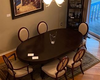 Barbara Barry for Baker Furniture Dining Table with X-Back Dining Chairs 
Oval Dining Table 
108” Width
48” Depth
29 3/4” Height 
Including Two 20" leaves and Protective Padding
The dimensions for the oval X-back dining Captain Chairs with Arms are…
27" Width
19 1/2" Depth
18” Seat Height 
38 1/2" Back Height
The oval X-back side chair dimensions are…
23" Wide
24" Depth
18” Seat Height 
38 1/2" Back Height
Magnificent signature design by Barbara Barry. Barbara Barry intends for her furniture designs to connect people to the splendor of the natural world around them. Barry’s admiration for organic materials and the subdued color palettes make her furniture designs timeless! Simple and calming, her furniture is quietly elegant and has garnered Barry renown worldwide as a leader in interior design. Barry has created exclusive furniture collections and home decor for other legendary brands as well…
In the style of modern 
Mahogany color