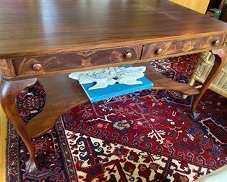 Flame mahogany drawers on desk.