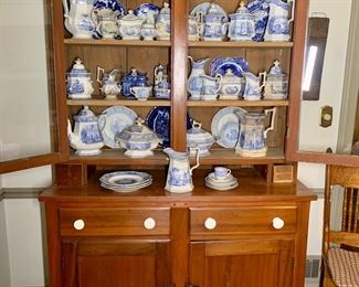 Victorian era hutch full of early Flow Blue pottery and blue Transferware serving pieces/dishes 