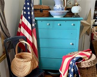 Antique dresser with mirror, old flags, handmade baskets, child size humpback travel trunk, oil lamps & stoneware