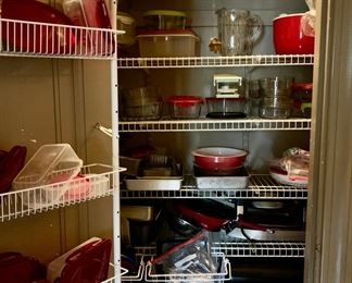 Pantry full of newer red farmhouse kitchen accoutrement 