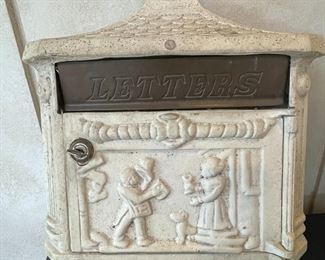 Vintage painted cast-iron wall mailbox.