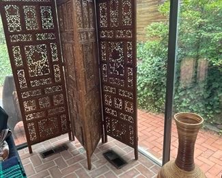 Four-paneled carved wooden screen.