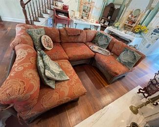 Vintage wicker sectional with needlepointed cabbage pillows.