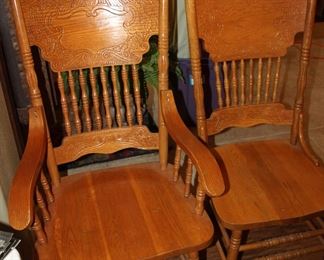 four oak press back chairs; one captain's chair and three side chairs