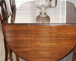 The table has two 20"leaves. It opens to seven feet and 42" wide. Has custom pads and a beautiful finish.