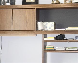 Desk with hutch top is full of office supplies.