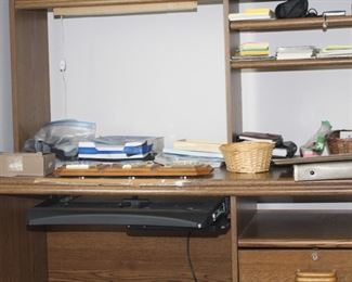 Computer desk is full of office supplies.