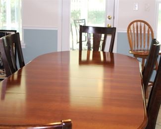 Casual contemporary table with six chairs. Table has two leaves 20 inches wide. It opens to 106"L x 43 1/2" wide.