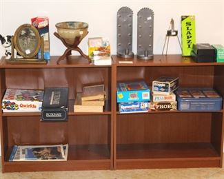 Two bookcases filled with games and decorative items.