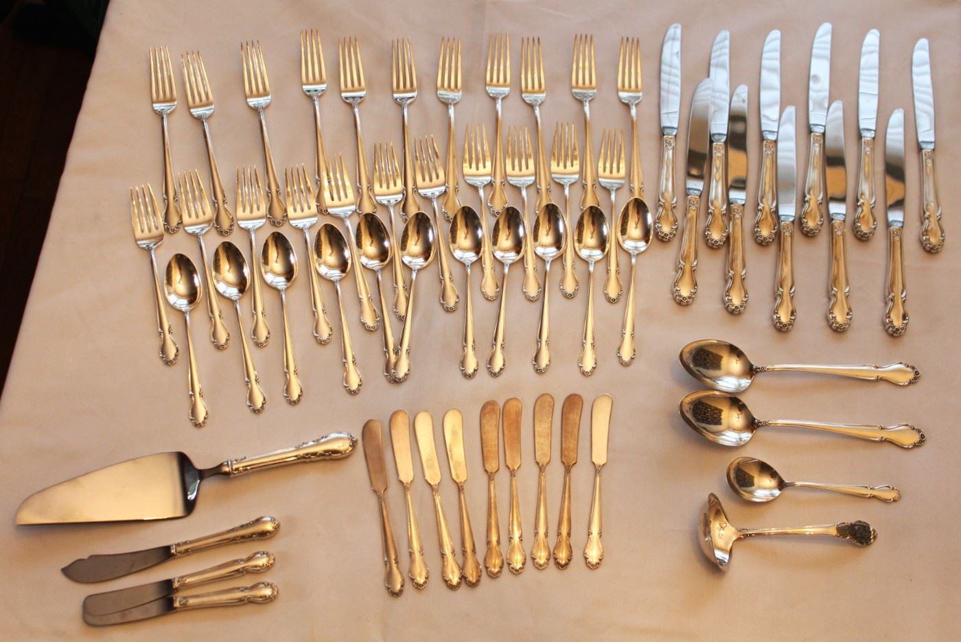 Rogers Wedding Bells sterling flatware set.  Four piece service for eleven plus serving pieces.  NOTE:  Silver and gold is never left unattended or on property overnight.