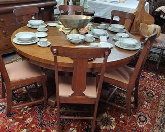 60 inch round oak table with 3 leaves and 6 T back. chairs.  The rug is an Agra 10x14