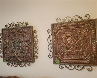 Antique tin ceiling tile in metal frames.