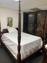 Queen bed with pineapples carved in the post Pinepple is a sign of hospitality.