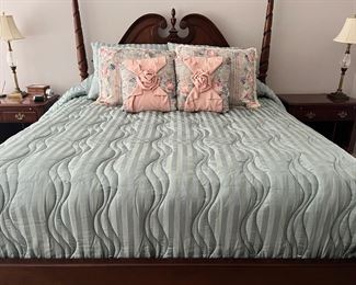 This custom bedding is king size with 4 shams and 2 accent pillows. It is displayed on a 4 poster Stanley bedroom suite. It comes with a pair of large 32” wide night stands with shelving below the pull out writing table and dresser with mirror.