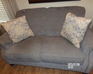 Ashley Furniture gray cloth loveseat w/pillows