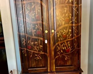 Armoire with tree painted on it