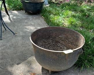 two cast iron kettles