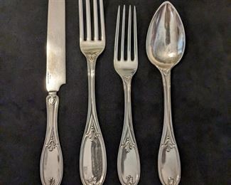 Flatware set marked sterling. 12 knives, 12 spoons, 4 dinner forks, 7 salad forks. All are monogrammed with initials.