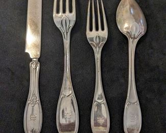 Flatware set marked sterling. 12 knives, 12 spoons, 4 dinner forks, 7 salad forks. All are monogrammed with initials.