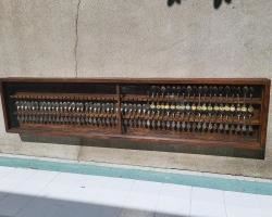 One long wooden display with collector spoons