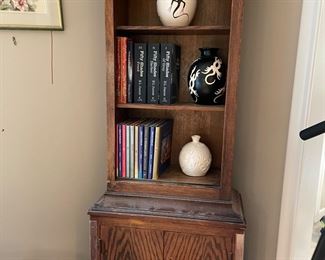 Oak Book shelf and signed pottery pieces.