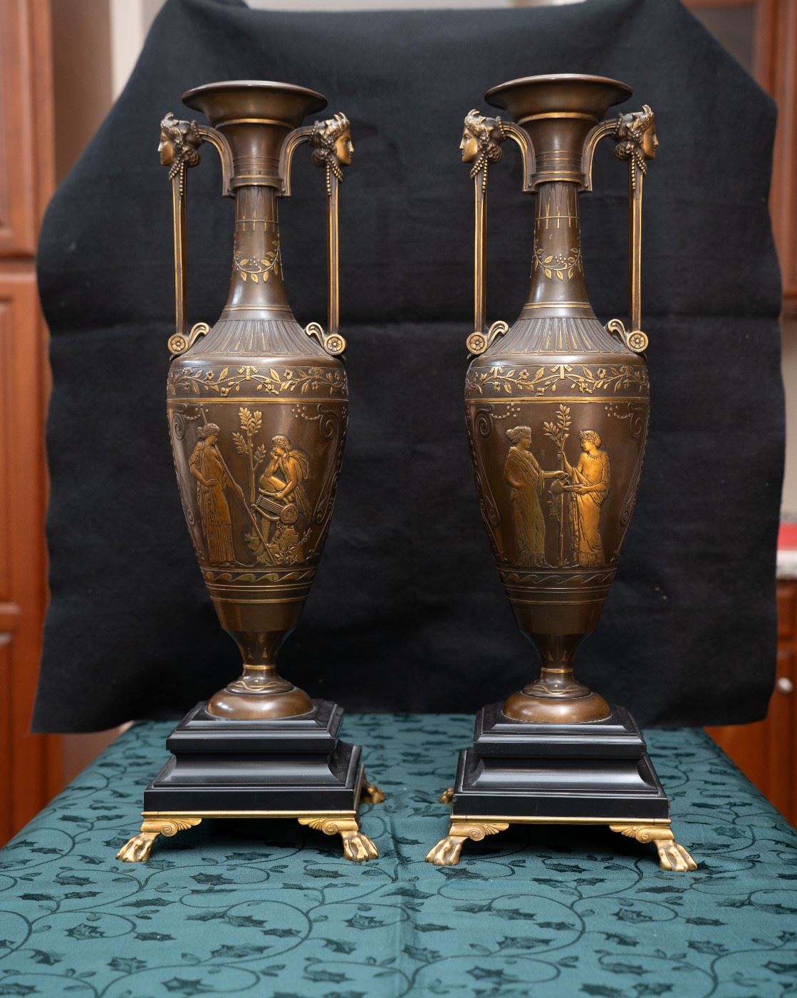 A wonderful and very high quality 19th. century French Greco-Egyptian St. ceremonial water vases in painted and gilt bronze. The complicated moulded Belgian black marble bases are supported with gilt lion claw feet to each corner. The body of the vases are decorated with Greek mythological figures in relief and are signed by the artist : Henry Cahieux (1810-1854)and forged and signed by : Ferdinand Barbedienne (1810-1892). Produced in France circa: 1850. 