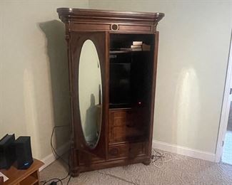 Solid wardrobe showing oval mirrors 